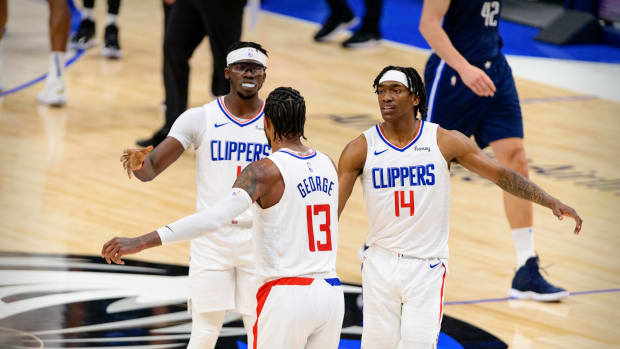May 28, 2021; Dallas, Texas, USA; LA Clippers guard Paul George (13) and guard Terance Mann (14) celebrate during the second quarter against the Dallas Mavericks in game three in the first round of the 2021 NBA Playoffs at American Airlines Center. Mandatory Credit: Jerome Miron-USA TODAY Sports